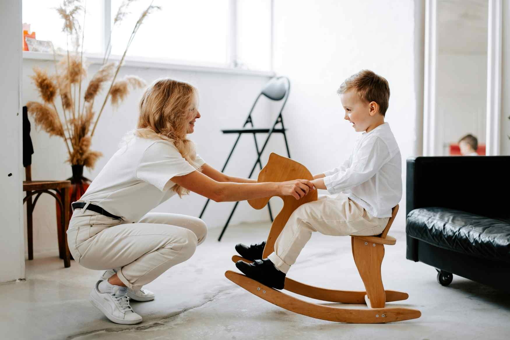 adult with child on toy horse
